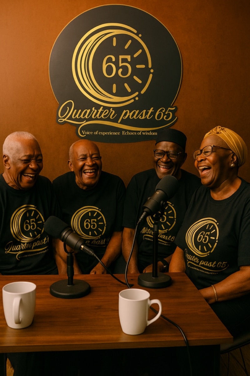 Elders laughing around the microphones in the Quarterpast 65 studio